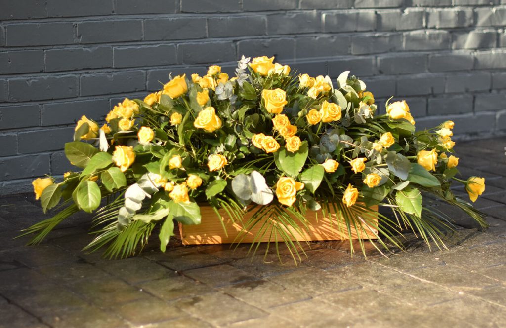 yellow casket spray