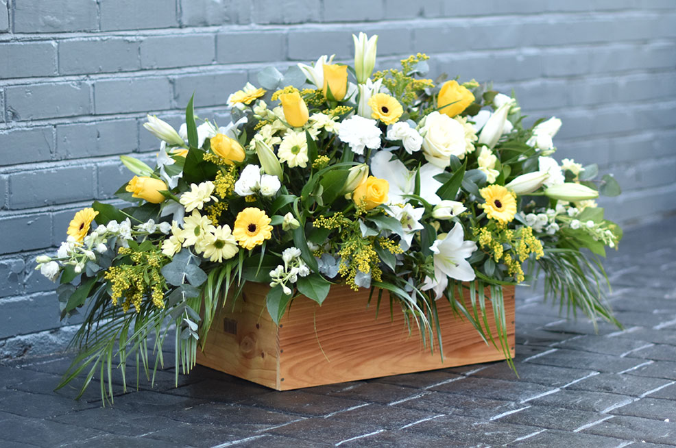 yellow white casket spray